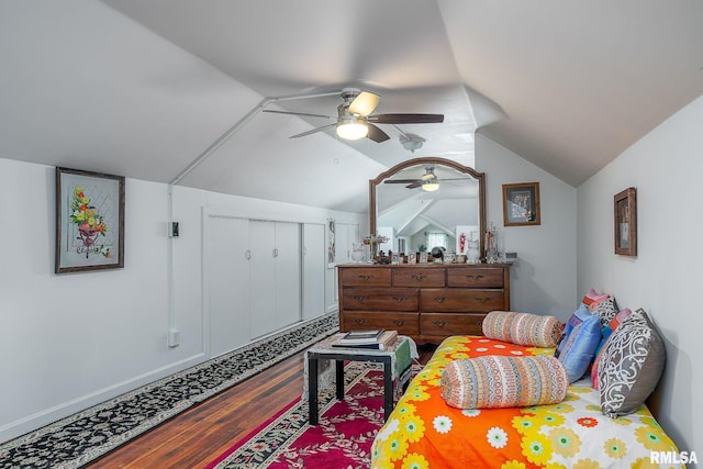 bedroom with a closet, dark wood-type flooring, a ceiling fan, and vaulted ceiling