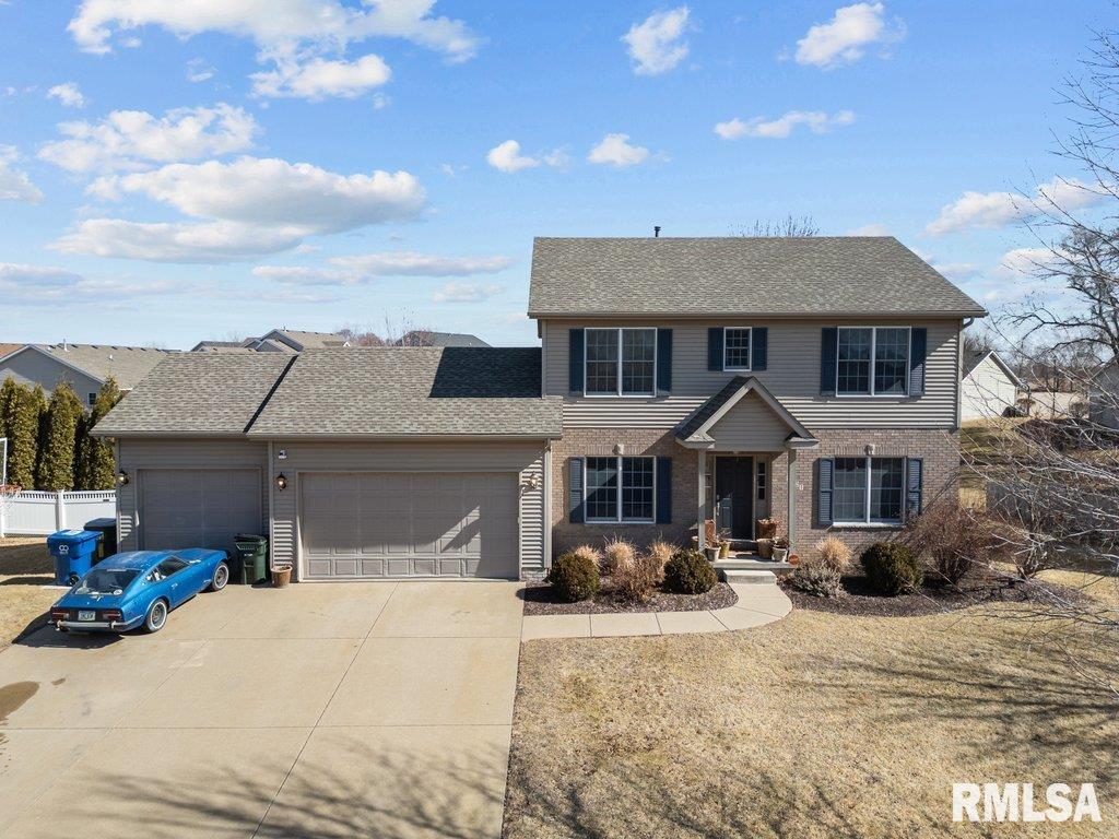 view of front of home featuring fence, concrete driveway, an attached garage, a shingled roof, and brick siding