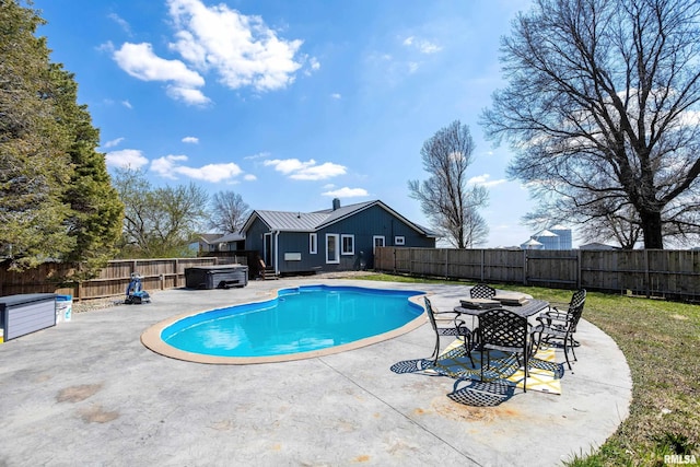 view of swimming pool with a patio area, a fenced backyard, and a hot tub