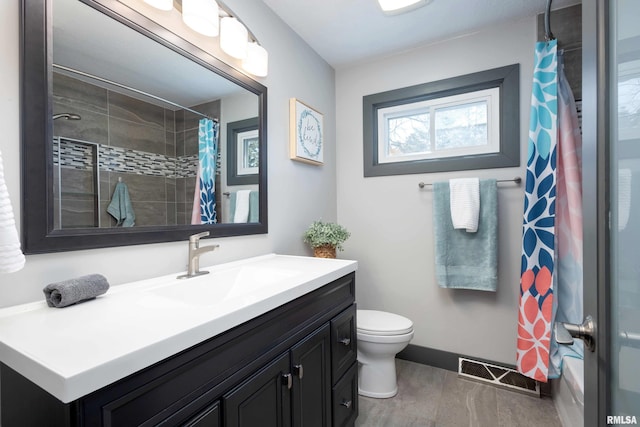 bathroom featuring visible vents, toilet, vanity, and baseboards