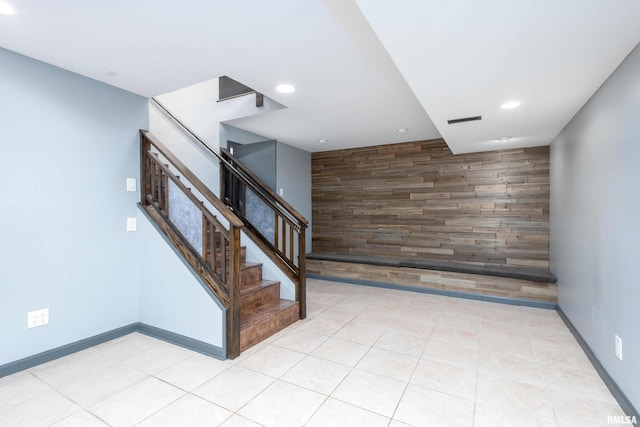stairway with an accent wall, visible vents, recessed lighting, tile patterned floors, and baseboards