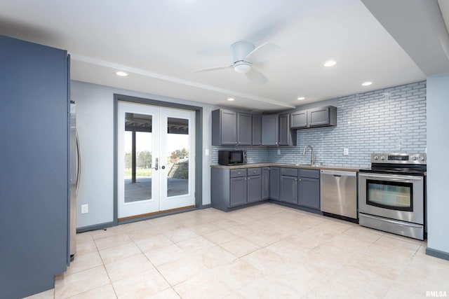 kitchen featuring a ceiling fan, gray cabinets, a sink, stainless steel appliances, and french doors