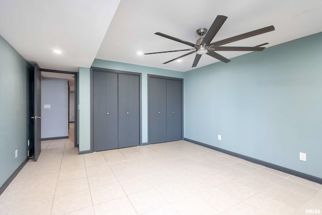 unfurnished bedroom with recessed lighting, baseboards, two closets, and a ceiling fan