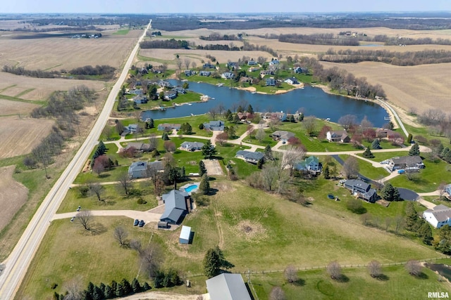 bird's eye view featuring a rural view, a residential view, and a water view