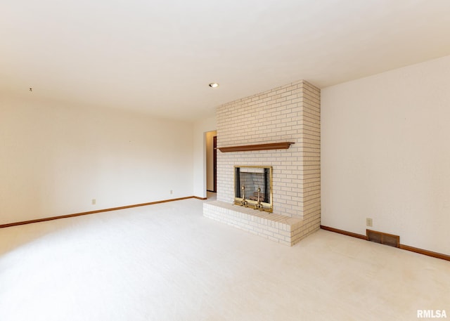 unfurnished living room featuring visible vents, baseboards, a brick fireplace, and carpet flooring