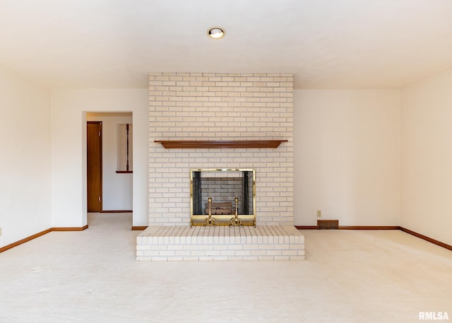 unfurnished living room with visible vents, baseboards, a brick fireplace, and carpet flooring