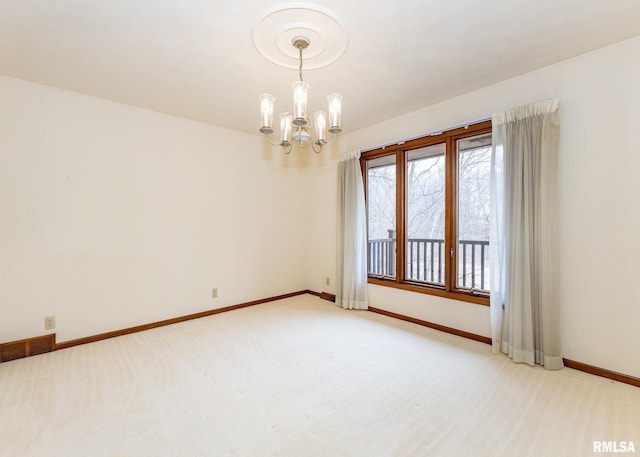 unfurnished room featuring an inviting chandelier, light colored carpet, and baseboards