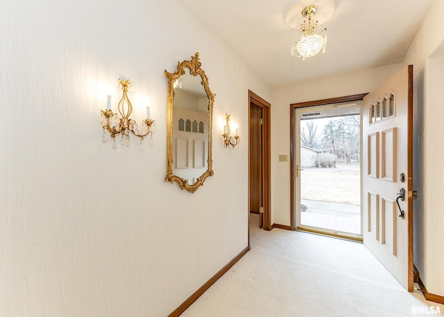 interior space with light colored carpet, baseboards, and an inviting chandelier