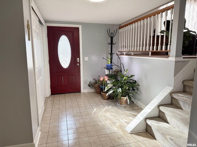 foyer with stairway and tile patterned flooring
