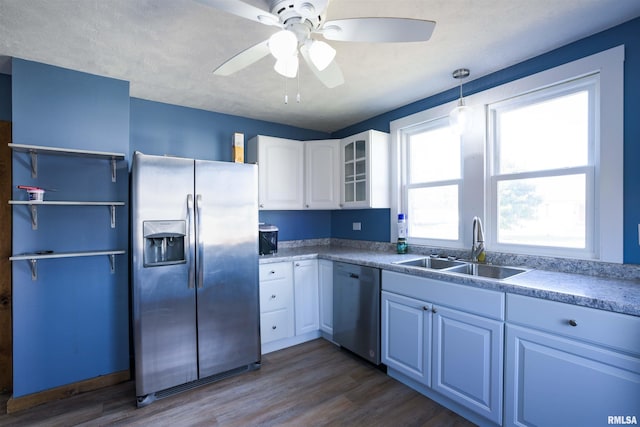 kitchen featuring a sink, ceiling fan, appliances with stainless steel finishes, white cabinets, and dark wood-style flooring