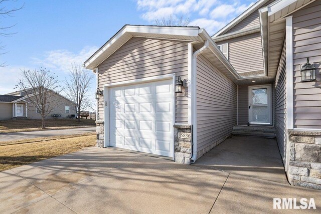 garage with concrete driveway