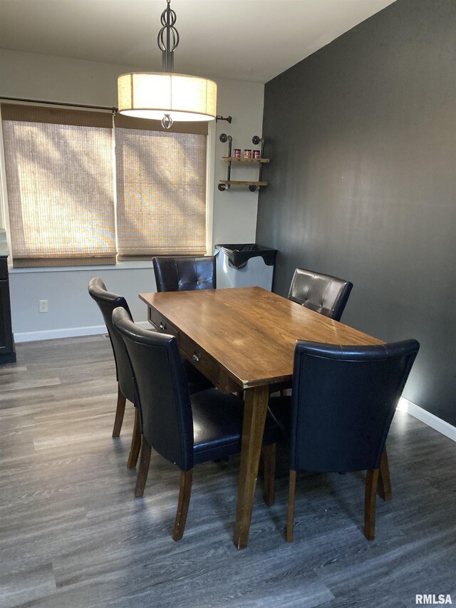dining area featuring baseboards and wood finished floors
