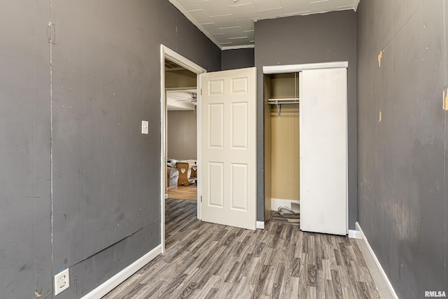 1500 W Tyler St, Herrin, IL 62948 - unfurnished bedroom featuring wood finished floors, a closet, and baseboards