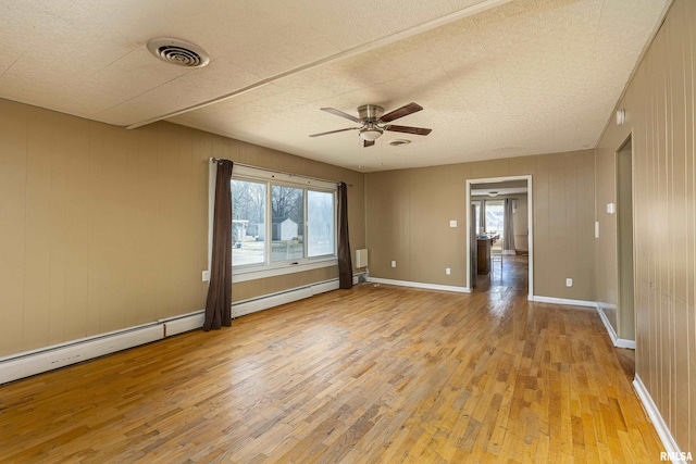 1500 W Tyler St, Herrin, IL 62948 - unfurnished room featuring visible vents, baseboards, light wood-style floors, and ceiling fan