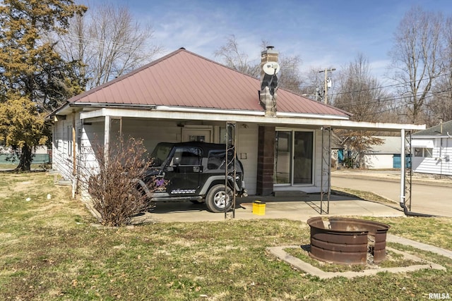 1500 W Tyler St, Herrin, IL 62948 - view of front of property featuring metal roof, a carport, a chimney, and a front lawn
