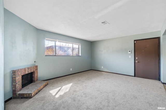 2501 26th Avenue Ct, Rock Island, IL 61201 - unfurnished living room with carpet flooring, baseboards, visible vents, and a fireplace
