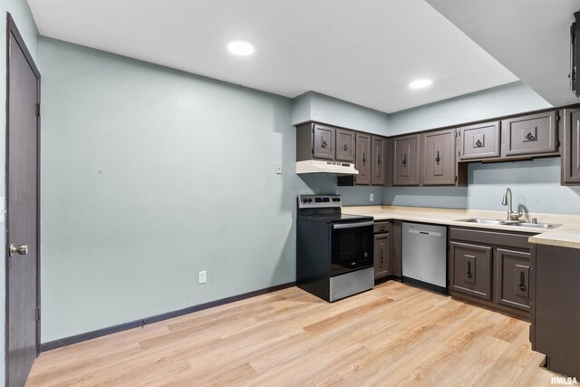 2501 26th Avenue Ct, Rock Island, IL 61201 - kitchen featuring under cabinet range hood, a sink, stainless steel appliances, light wood-style floors, and light countertops