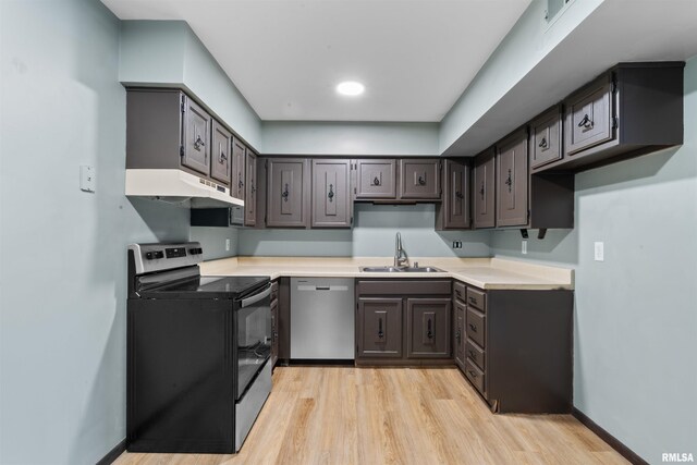 2501 26th Avenue Ct, Rock Island, IL 61201 - kitchen with light wood-type flooring, electric stove, under cabinet range hood, a sink, and dishwasher