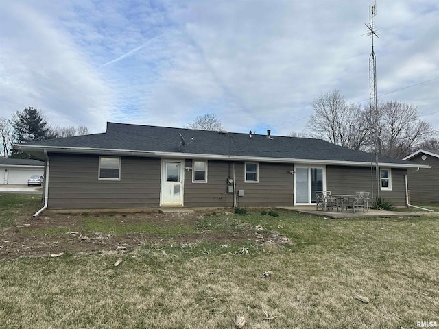 rear view of property featuring a patio and a yard
