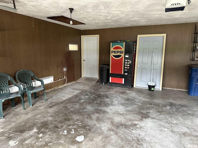 garage featuring wooden walls, ceiling fan, and refrigerator