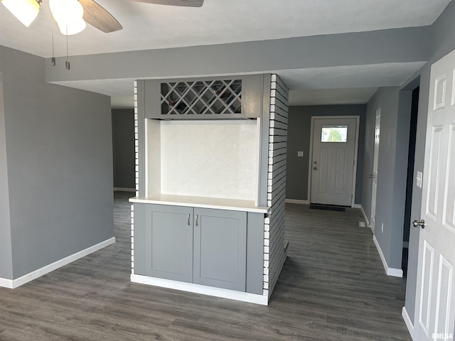 interior space featuring baseboards and dark wood-type flooring
