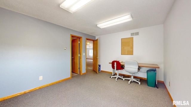 carpeted home office with visible vents, baseboards, and a textured ceiling