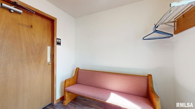 sitting room featuring baseboards and wood finished floors