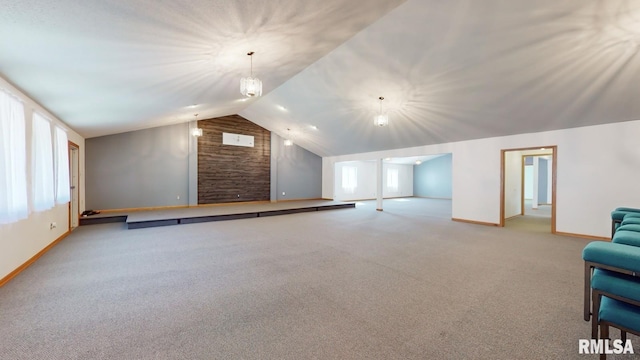 interior space with lofted ceiling, baseboards, and carpet floors