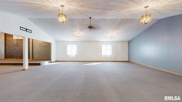 carpeted spare room featuring a textured ceiling, baseboards, a notable chandelier, and vaulted ceiling