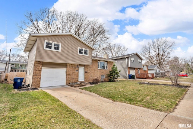 split level home featuring driveway, an attached garage, a chimney, a front lawn, and brick siding
