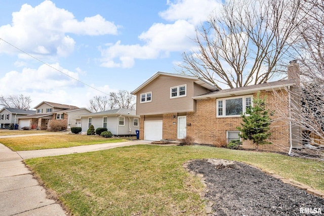 split level home with brick siding, concrete driveway, a garage, and a front yard