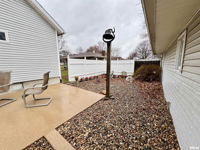 view of yard featuring fence and a patio area