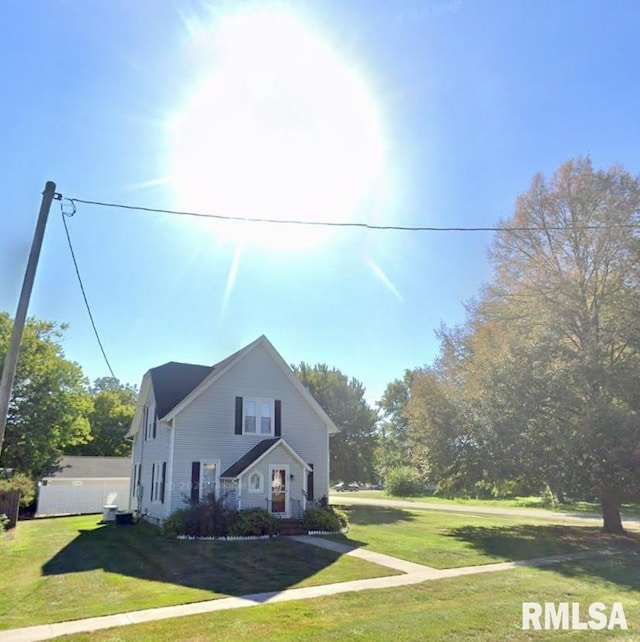 view of front of house with a front lawn and fence