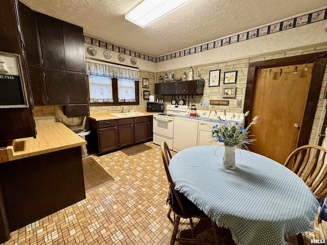 kitchen featuring white range with electric stovetop, a textured ceiling, a sink, dark brown cabinets, and black microwave