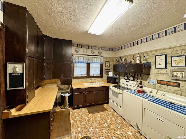 kitchen featuring white range with electric stovetop, a textured ceiling, a sink, washer and dryer, and black microwave