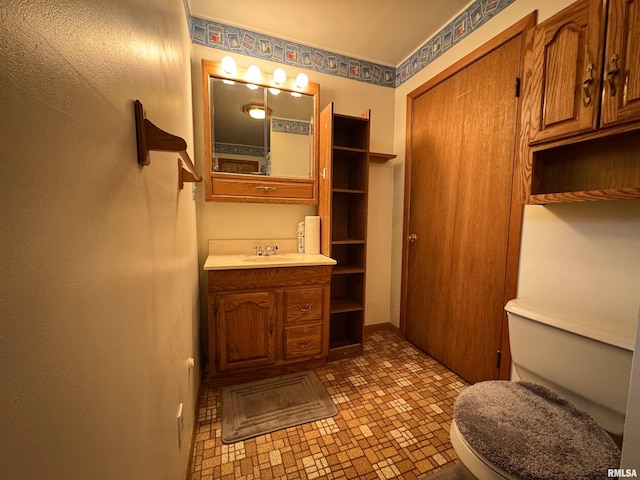 half bath featuring toilet and vanity