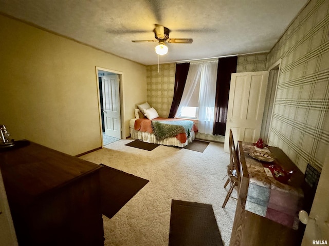 carpeted bedroom with a ceiling fan, wallpapered walls, baseboards, and a textured ceiling
