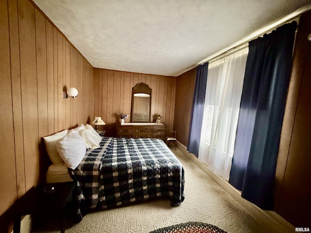 bedroom featuring wooden walls