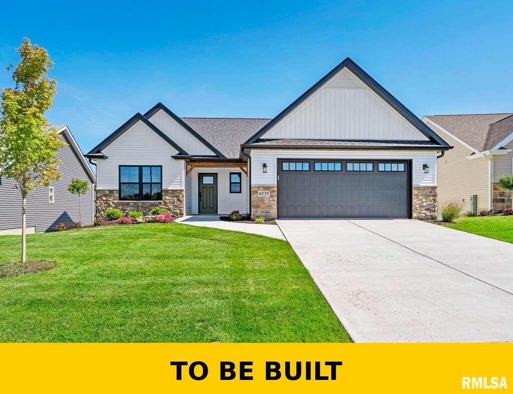 view of front of home with stone siding, a garage, board and batten siding, and a front yard