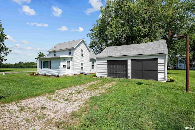 exterior space with a front yard, a garage, and an outdoor structure