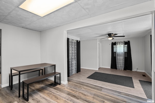 foyer entrance with visible vents, baseboards, a ceiling fan, and wood finished floors