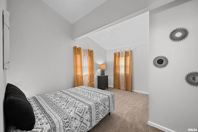 carpeted bedroom with vaulted ceiling with beams and baseboards