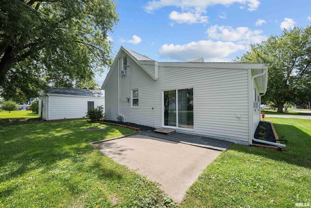 back of house featuring a patio and a yard