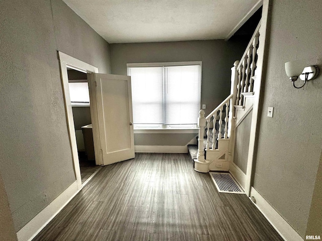 interior space with visible vents, baseboards, and wood finished floors