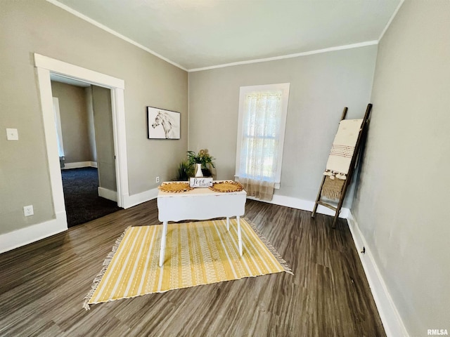 dining space featuring baseboards, wood finished floors, and ornamental molding