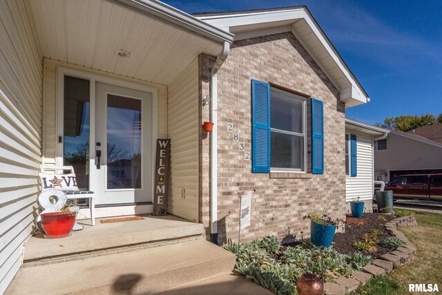 entrance to property with brick siding
