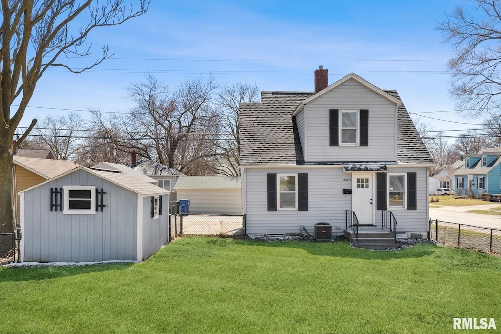 2503 Bellevue Ave, Bettendorf, IA 52722 - view of front of house with a fenced backyard, a chimney, a shingled roof, and a storage unit