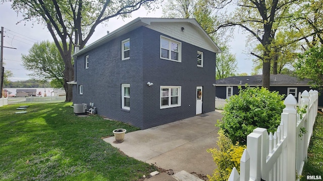22690 282nd Ave, Le Claire, IA 52753 - view of home's exterior featuring central AC, brick siding, and a patio area