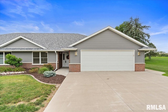 19109 Bluff Rd Unit D, Geneseo, IL 61254 - view of front of property featuring brick siding, driveway, a front lawn, and a garage