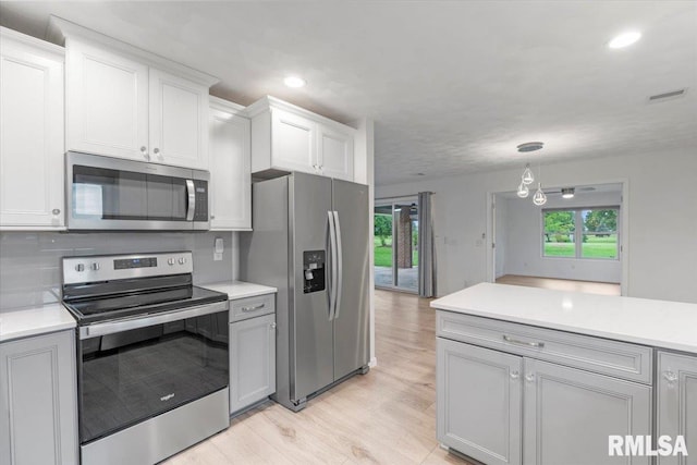 19109 Bluff Rd Unit D, Geneseo, IL 61254 - kitchen featuring stainless steel appliances, light countertops, light wood-style floors, recessed lighting, and tasteful backsplash
